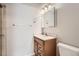 Bathroom featuring wood vanity with light countertop, a large framed mirror, and white walls, offering a clean and functional space at 2231 S Vaughn Way # 205B, Aurora, CO 80014