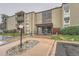 Condo building exterior with a landscaped entrance and visible balconies on upper floors in a clean and tidy setting at 2231 S Vaughn Way # 205B, Aurora, CO 80014