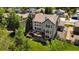 Aerial view of backyard with deck and lush green grass surrounded by trees at 10 Sand Cherry, Littleton, CO 80127