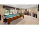 Finished basement with pool table, fireplace, walkout access, and carpeted flooring at 10 Sand Cherry, Littleton, CO 80127