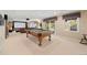 Spacious finished basement with a pool table, media area, and walkout access at 10 Sand Cherry, Littleton, CO 80127