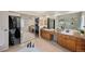 Spacious bathroom featuring double vanity, granite counters, walk-in closet and tiled shower at 10 Sand Cherry, Littleton, CO 80127