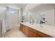 Bright bathroom featuring double sink vanity, tiled flooring and shower/tub at 10 Sand Cherry, Littleton, CO 80127