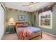 Bedroom with decorative wallpaper trim, wooden bedframe and view to exterior at 10 Sand Cherry, Littleton, CO 80127
