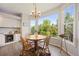 Bright breakfast nook features a round table, wood chairs, and a large window with scenic views at 10 Sand Cherry, Littleton, CO 80127