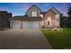 Charming two-story home featuring a three-car garage, brick accents, and a beautifully landscaped front yard at 10 Sand Cherry, Littleton, CO 80127