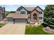Charming home featuring brick and siding, a three-car garage, and well-manicured landscaping at 10 Sand Cherry, Littleton, CO 80127