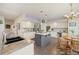 Stylish kitchen featuring white cabinets, stainless steel appliances, granite countertops, and hardwood floors at 10 Sand Cherry, Littleton, CO 80127