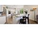 Modern kitchen features white cabinets, granite countertops, stainless steel appliances, and a breakfast bar at 10 Sand Cherry, Littleton, CO 80127