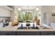 Contemporary kitchen island with cooktop and views of breakfast nook and outdoor scenery at 10 Sand Cherry, Littleton, CO 80127