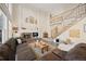 Bright living room boasts high ceilings, a brick fireplace, and a grand staircase to the second floor at 10 Sand Cherry, Littleton, CO 80127