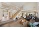 Spacious living room featuring a grand staircase, hardwood floors and ample natural light at 10 Sand Cherry, Littleton, CO 80127