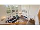 Bright living room features soaring ceilings, a brick fireplace, and a wall of windows offering scenic views at 10 Sand Cherry, Littleton, CO 80127