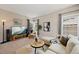 Inviting living room features neutral tones, a sectional sofa, and ample natural light at 10 Sand Cherry, Littleton, CO 80127