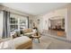 Cozy living room with comfortable seating and an open layout connected to the dining area at 10 Sand Cherry, Littleton, CO 80127