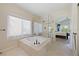 Luxurious primary bathroom with a soaking tub, glass shower, and elegant tile work at 10 Sand Cherry, Littleton, CO 80127
