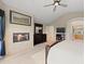 Spacious primary bedroom featuring a fireplace, dresser, and access to the ensuite bathroom at 10 Sand Cherry, Littleton, CO 80127