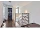 Hallway with modern railing, a laundry room sign, and stacked washer and dryer at 1840 Irving St, Denver, CO 80204