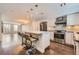 Bright kitchen featuring stainless steel appliances, a center island with bar seating, and modern light fixtures at 1840 Irving St, Denver, CO 80204