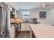 Kitchen featuring stainless steel appliances, tile backsplash, light wood cabinets, and quartz countertops at 1840 Irving St, Denver, CO 80204