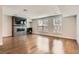Open living room with hardwood floors, large windows, and a modern fireplace with built-in shelving at 1840 Irving St, Denver, CO 80204
