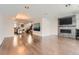 Bright, open living area with hardwood floors, a fireplace, and an open kitchen floor plan at 1840 Irving St, Denver, CO 80204
