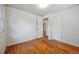 Bedroom with hardwood floors, bright light from the window, and doorways to adjoining rooms at 5240 Dudley St, Arvada, CO 80002