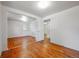 Empty bedroom featuring hardwood floors, bright light and doorways leading to adjoining rooms at 5240 Dudley St, Arvada, CO 80002