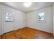 Cozy bedroom with hardwood floors, natural light from windows, and an exterior door for easy access at 5240 Dudley St, Arvada, CO 80002
