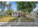 Charming single-story home with a covered porch, mature tree, and fenced front yard at 5240 Dudley St, Arvada, CO 80002
