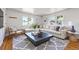 Bright living room with large sectional, modern rug, and lots of natural light at 5240 Dudley St, Arvada, CO 80002