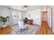 A home office with modern decor featuring a large window and new floors at 5240 Dudley St, Arvada, CO 80002