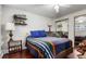 Inviting bedroom with hardwood floors, comfortable bedding, and a mirrored closet, designed for restful nights at 1833 N Williams St # 101, Denver, CO 80218