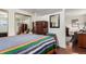 Comfortable bedroom with hardwood floors, ample closet space, and a view into the living room at 1833 N Williams St # 101, Denver, CO 80218
