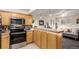 Well-equipped kitchen with stainless appliances, granite counters and light wood cabinets open to the living area at 1833 N Williams St # 101, Denver, CO 80218