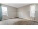 Nice sized bedroom has newer carpet, clean white trim, and good natural light from two windows at 14046 E Stanford Cir # I04, Aurora, CO 80015