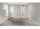 Large bedroom shows neutral walls, soft newer carpet and clean white trim with two doors nearby at 14046 E Stanford Cir # I04, Aurora, CO 80015