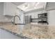 Kitchen with white cabinets, granite countertop, and stainless steel appliances at 14046 E Stanford Cir # I04, Aurora, CO 80015