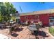 Outdoor patio seating area of The Plymouth restaurant, featuring brick pavement and greenery at 3739 E 26Th Avenue Pkwy, Denver, CO 80205