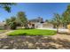 Expansive backyard with lush lawn, mature trees, and wooden pergola on the patio at 4351 E 109Th Ave, Thornton, CO 80233