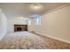 Finished basement area with a brick fireplace and carpeted floor at 4351 E 109Th Ave, Thornton, CO 80233