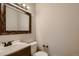 Powder bath features a wood-trimmed mirror, vanity sink, and toilet at 4351 E 109Th Ave, Thornton, CO 80233