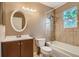 Bathroom featuring tub with shower, toilet, vanity with mirror, and window at 4351 E 109Th Ave, Thornton, CO 80233