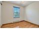 Bright bedroom featuring hardwood floors and a window with blue blinds at 4351 E 109Th Ave, Thornton, CO 80233