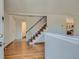 Welcoming entryway with hardwood floors and staircase with metal railing at 4351 E 109Th Ave, Thornton, CO 80233