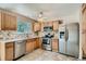 Well-lit kitchen features stainless steel appliances, tile backsplash, and ample cabinet space at 4351 E 109Th Ave, Thornton, CO 80233