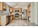 Well-lit kitchen features stainless steel appliances, tile backsplash, and ample cabinet space at 4351 E 109Th Ave, Thornton, CO 80233