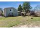 Spacious backyard with a covered patio, swing set and green lawn at 9375 W David Ave, Littleton, CO 80128