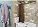 This full bathroom includes modern tiling and a shower with curtain at 9375 W David Ave, Littleton, CO 80128