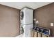 This laundry room features modern, stacked washer and dryer units at 9375 W David Ave, Littleton, CO 80128